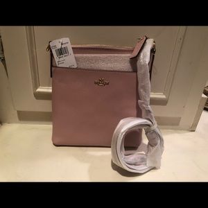 COACH  lt. pink crossbody, with adjustable strap.